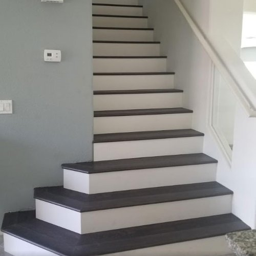 gray wood stairs provided and installed by Budget Flooring & Shutters in Las Vegas, NV